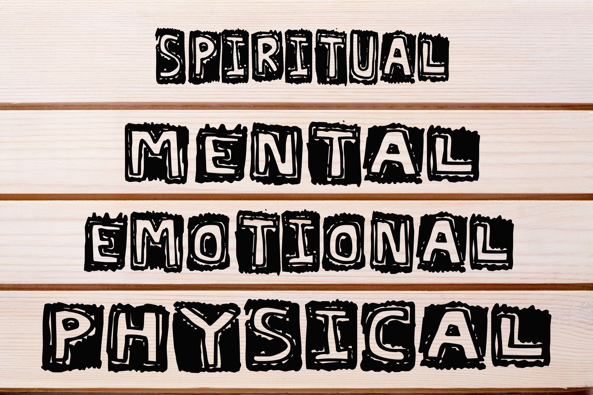 Mental spiritual emotional physical written on wood wall decor.