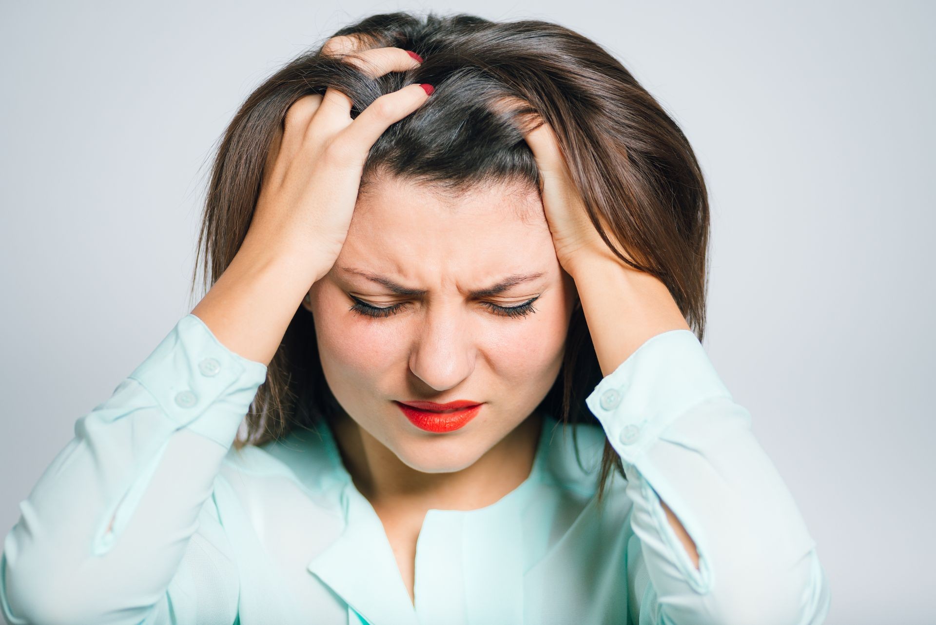 Portrait of a young woman has a headache, migraine, closeup