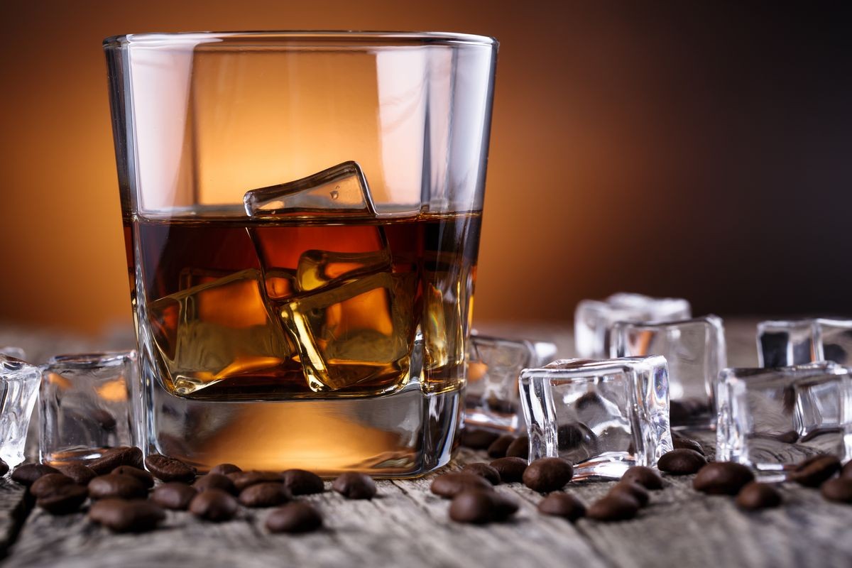 Alcohol on a wooden table with coffee beans.