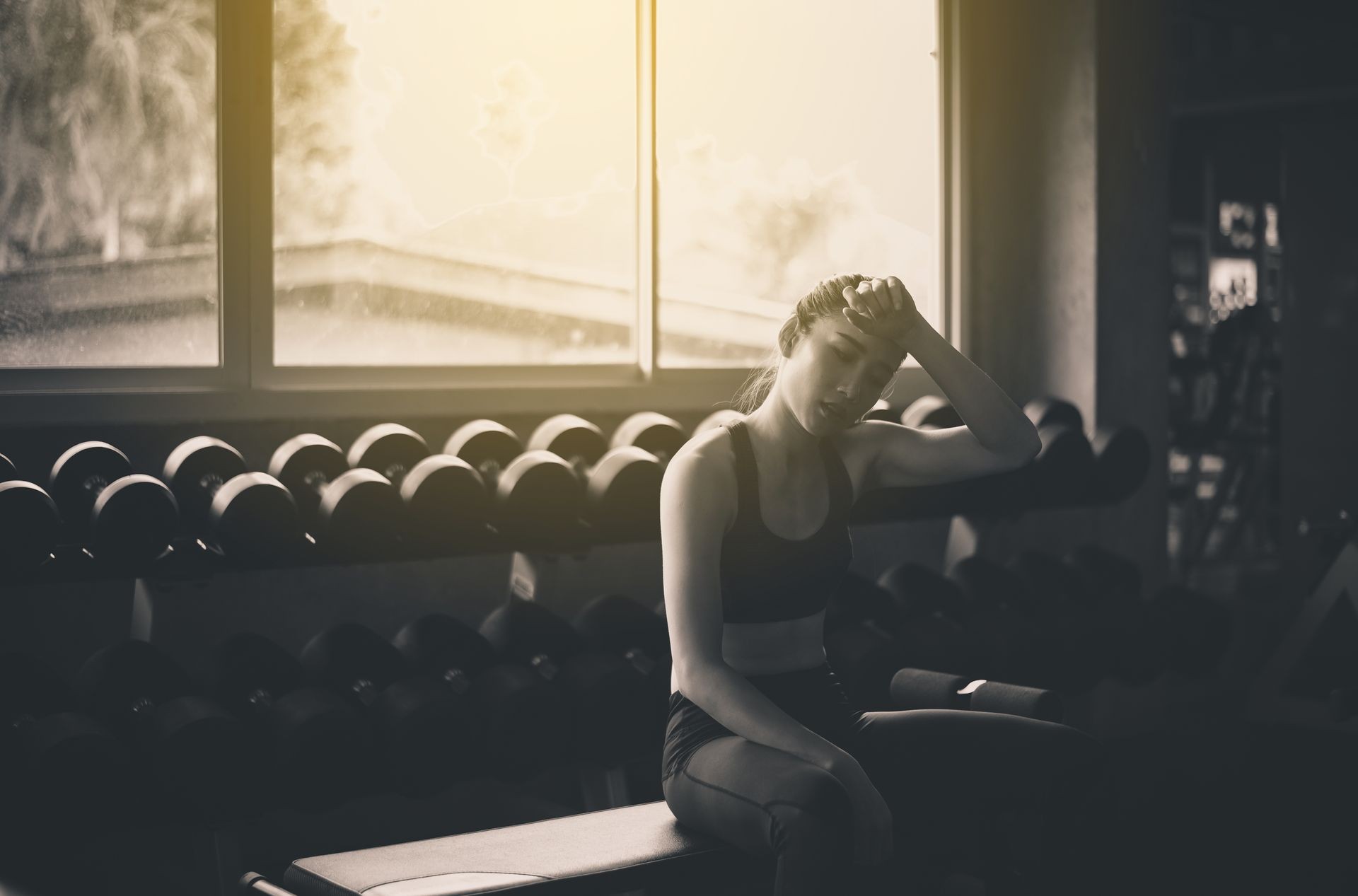 Fit asian woman tired and relax after the training session,Female taking a break after exercise and workout,Concept healthy and lifestyle,Black and white toned